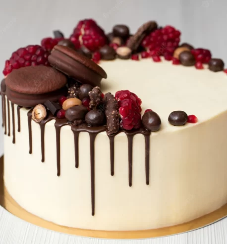 attachment-https://ravbakers.com/wp-content/uploads/2013/06/cake-with-white-cream-chocolate-drips-pomegranate-nuts-chocolate-decor_199620-5923-458x493.webp