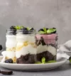 attachment-https://ravbakers.com/wp-content/uploads/2013/06/layered-desserts-with-cake-whipped-cream-blackberries-mason-jars_132278-957-100x107.webp